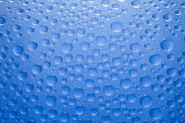 Water drops blue background. Water drops on glass background