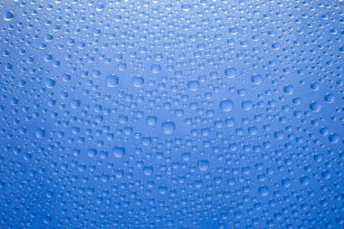 Water drops blue background. Water drops on glass background