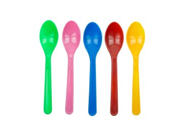 colorful plastic spoons for party isolated on white