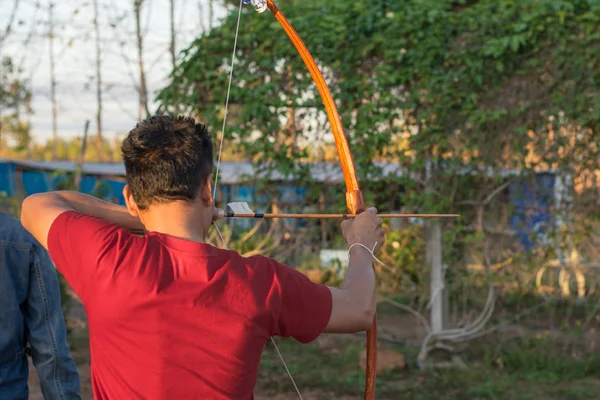 man archer takes aim at a target
