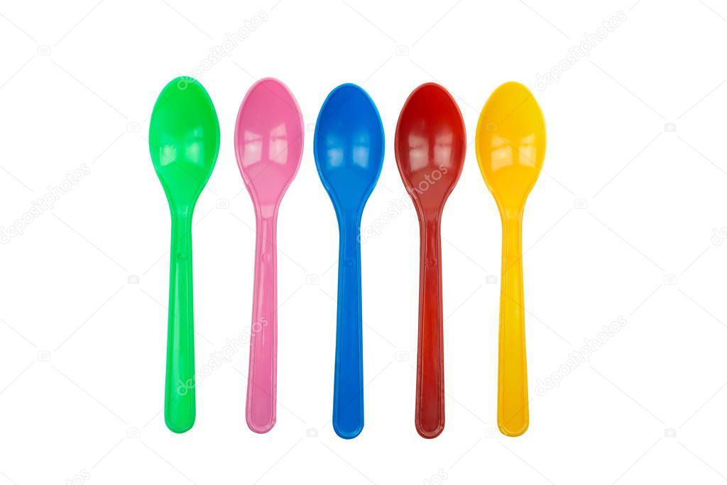 colorful plastic spoons for party isolated on white