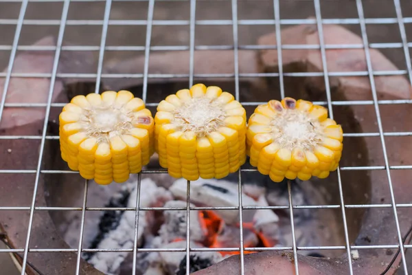 Cooking several fresh yellow brown golden corn cobs