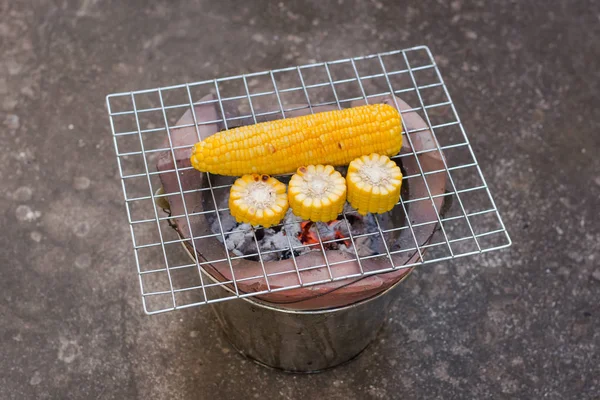 Cooking several fresh yellow brown golden corn cobs