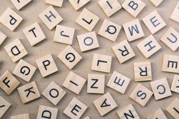 background of  letterpress wood type printing blocks, random letters of alphabet and punctuation stained by black inks