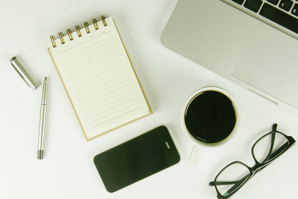 White office desk table with a lot of things on it. Top view with copy space.
