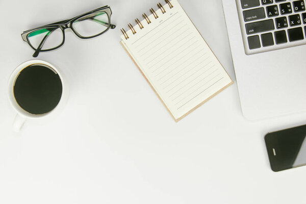 White office desk table with a lot of things on it. Top view with copy space.