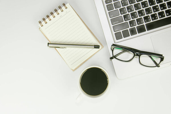 White office desk table with a lot of things on it. Top view with copy space.