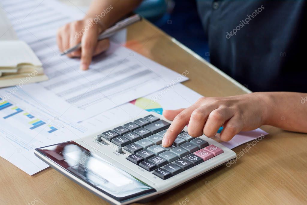 woman hand using calculator and writing make note with calculate