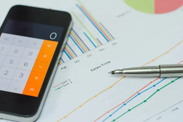 Data analyzing sheet. with calculator mobile phone and pen. from charts and graph to find out the result.