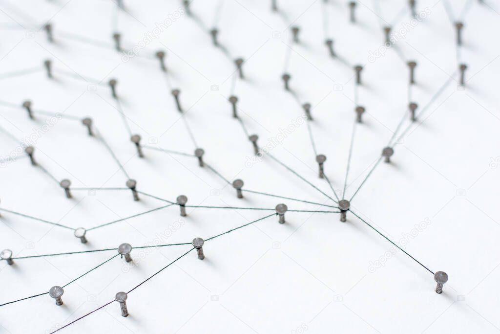 Linking entities. Network, networking, social media, internet communication abstract. A small network connected to a larger network. in paper linked together by cotton with a black tint