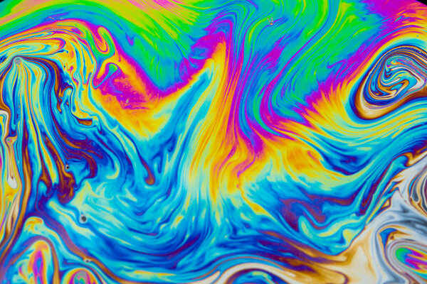 Psychedelic multicolored patterns background. Photo macro shot of soap bubbles