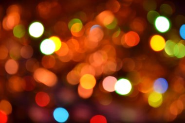 Turuncu ve kırmızı bokeh. Boke 'un arka planı. Soyut doku. Renkli daireler. Bulanık.