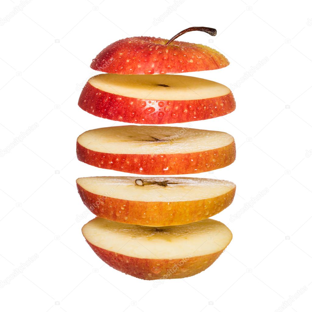 Flying apple. Sliced red apple isolated on white background.