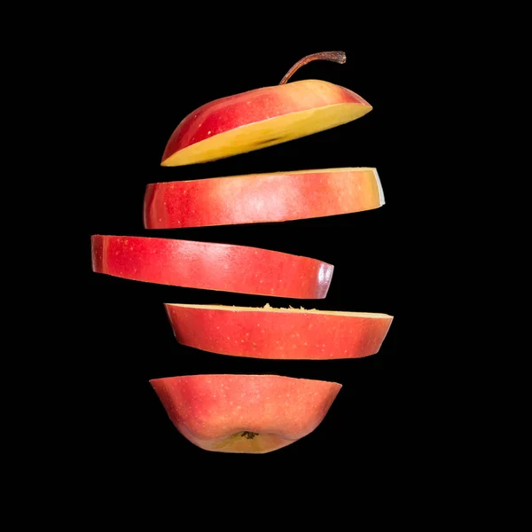 Flying apple. Sliced red apple isolated on black background. Levity fruit — Stock Photo, Image
