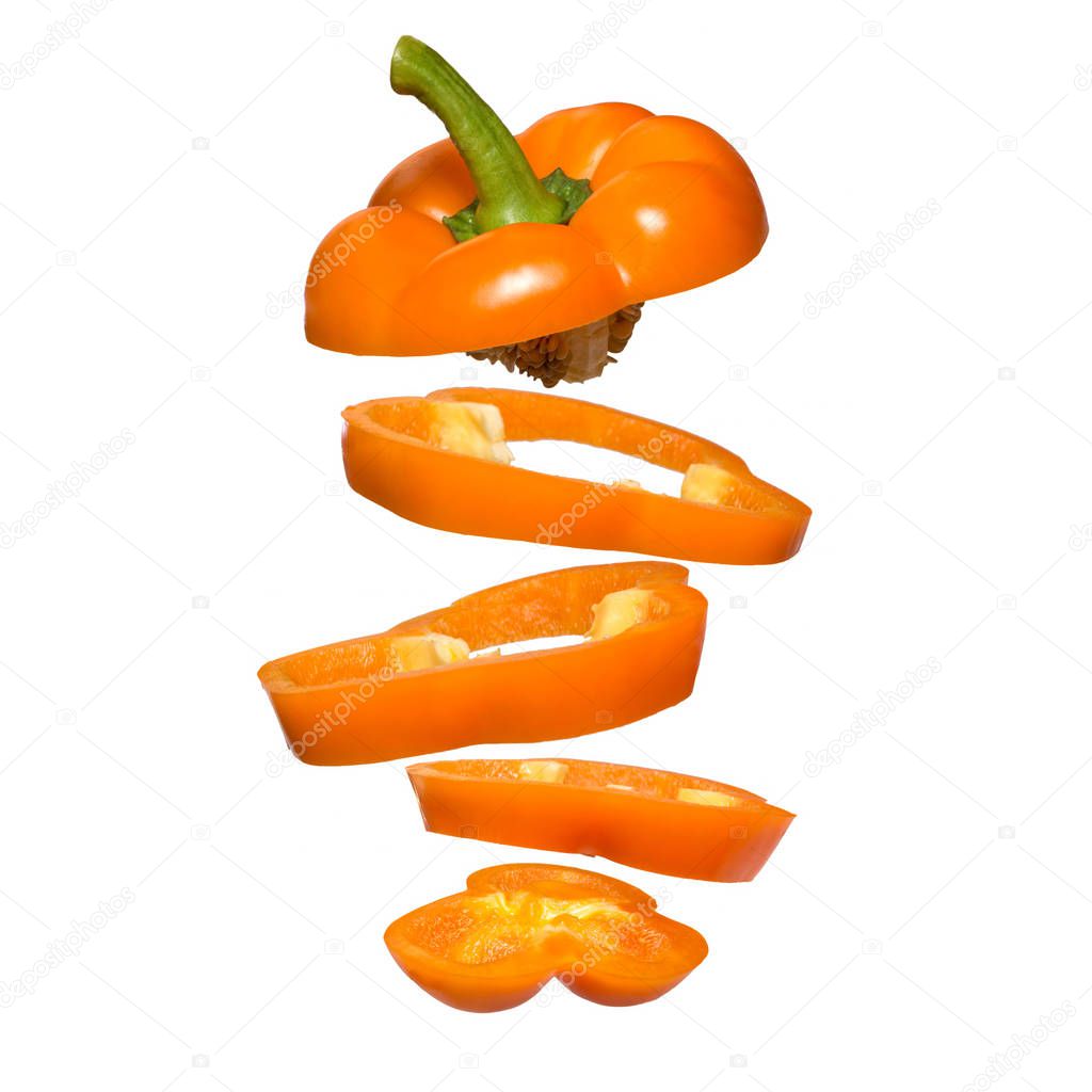Flying yellow paprika. Sliced floating pepper isolated. Levity vegetable.