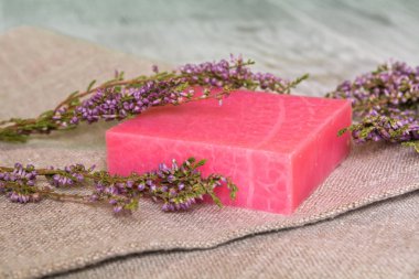 Doğal el yapımı Sabun ve keten bir arka plan üzerinde heather bir dal