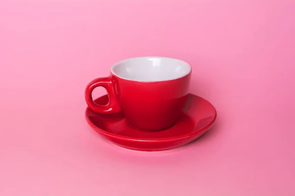 Red coffee cup and saucer on a pink background — Stock Photo, Image