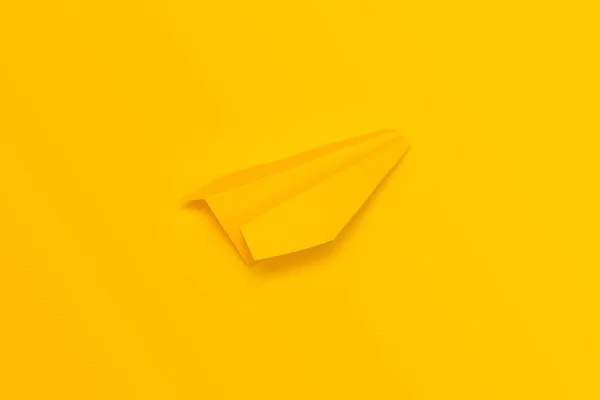 Pesawat origami kuning dengan latar belakang kuning. Lihat dari atas — Stok Foto