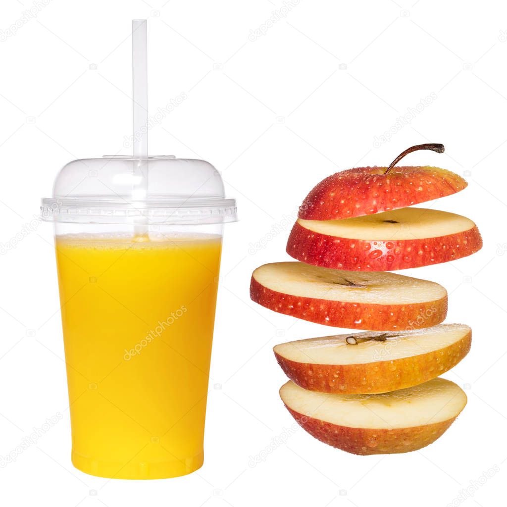 Fresh apple juice in transparent glass with a tube. Creative flying fruit apple