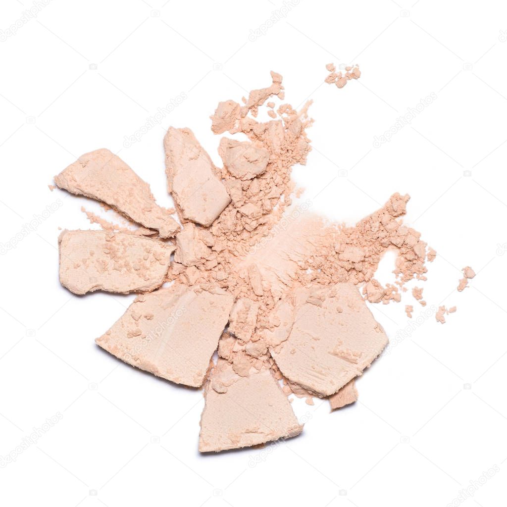 A sample of face powder in white. Beige round cracked powder palette