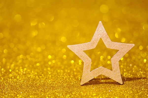 Shining star on a golden radiant background. Glitter shine with shape of star