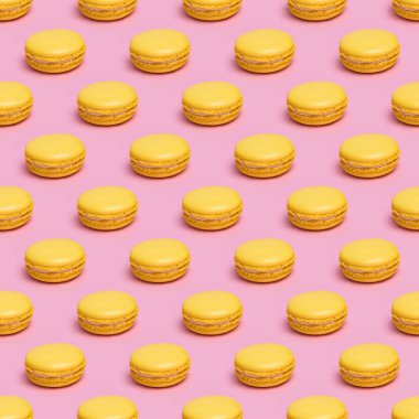 Pembe arka planda sarı Macaron kurabiyeleri ile Dikişsiz desen.