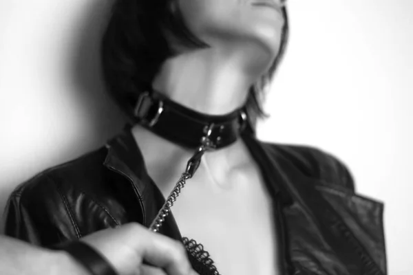 Beautiful sexy woman slave with chain collar. Domination concept. Adult BDSM games. Focus on the chain.