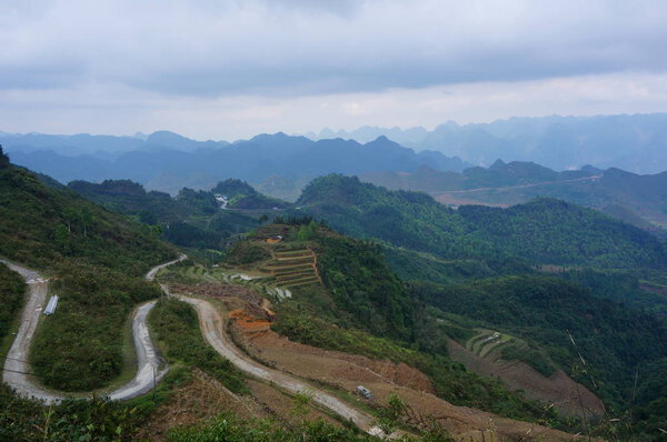 View over mountain valley and winding road in Ha Giang province, Northern Vietnam