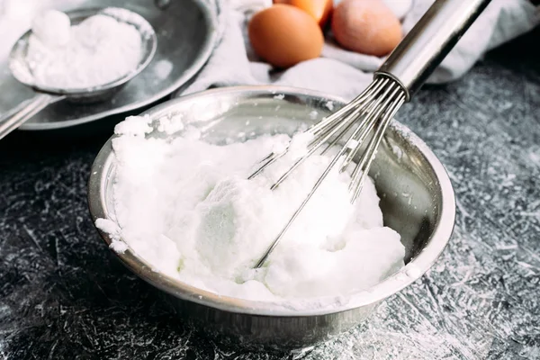 Whipped egg white into a thick foam. Plate with egg whipped white,whisk, meringue