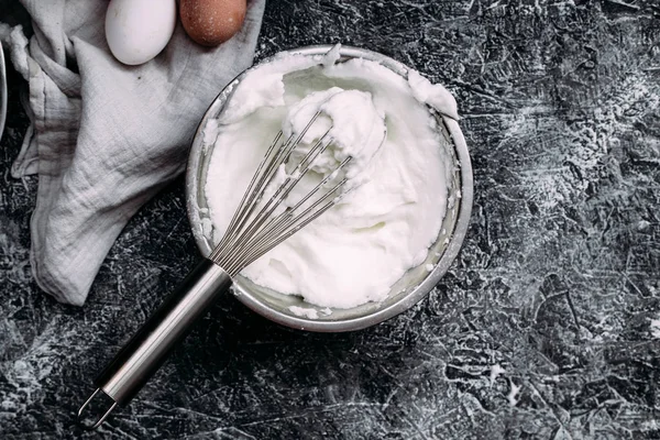 Whipped egg white into a thick foam. Plate with egg whipped white,whisk, meringue