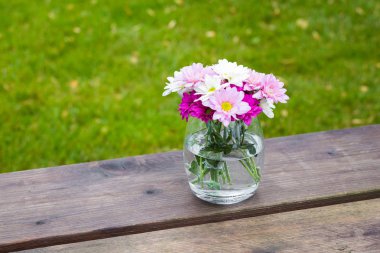 Cam vazoda renkli pembe yaz çiçek