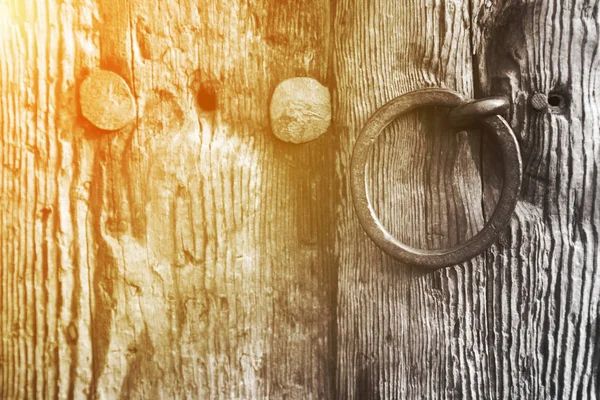 Old rustic wooden door with a ring handle — Stock Photo, Image