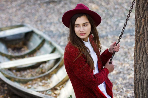 Menina bonito em vermelho casaco de lã e chapéu no outono — Fotografia de Stock