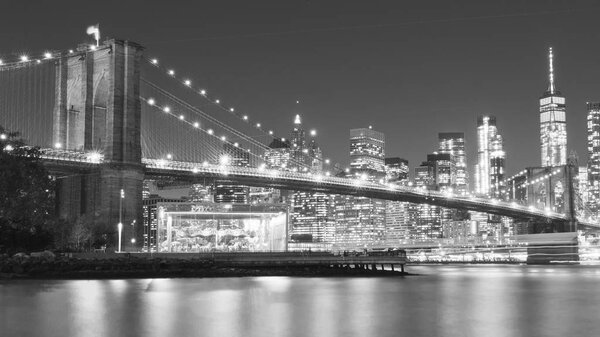 A magnificent view of the lower Manhattan and Brooklyn Bridge , black and white