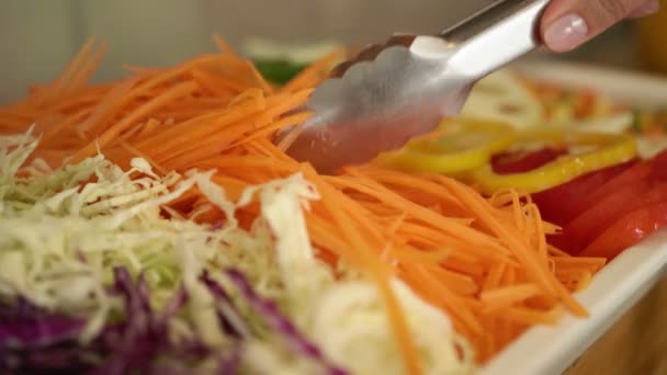 Woman taking salad bar in buffet — Stock Video