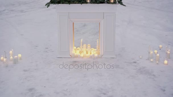 Candles in fireplace ourdoors — Stock Video