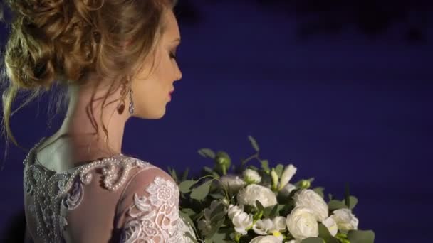 Young woman in white dress near fireplace decoration on frozen lake — Stock Video