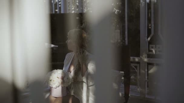 Carino giovane donna bionda in lingerie seduta con mazzo di fiori sparato attraverso la finestra — Video Stock