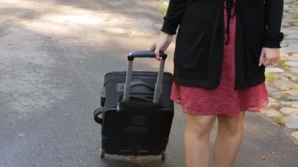 Woman with suitcase bag on wheels — Stock Video