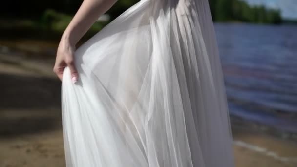 Bride in wedding dress waving cloth at wind — Stock Video