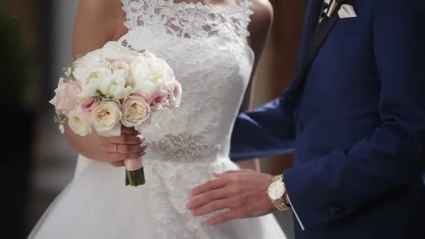 Bride and groom embracing and walking on a street — Stock Video