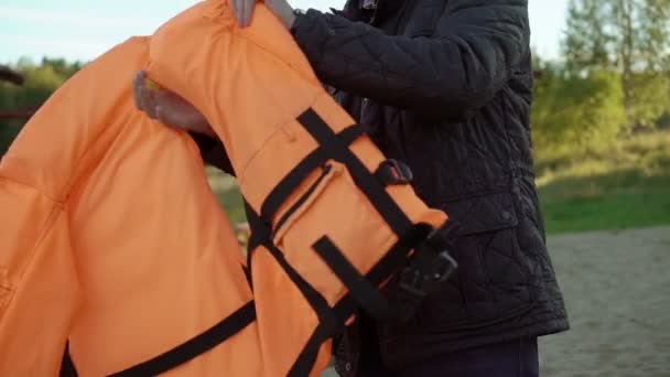 Young man wearing life jacket — Stock Video