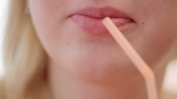 Ung blondine kvinde drikker gennem strå – Stock-video