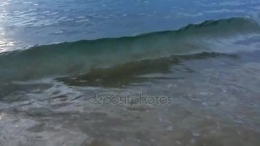 Akşam saatlerinde kumsalda dalgalar sörf