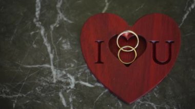 İki alyans ve i love you işareti