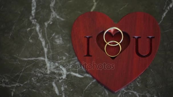 Two wedding rings and i love you sign — Stock Video