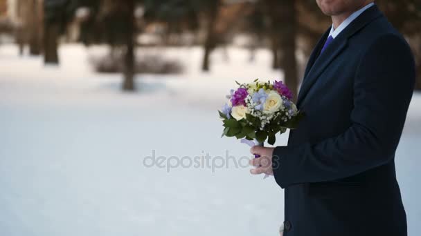 Мужчина с букетом цветов ждет — стоковое видео