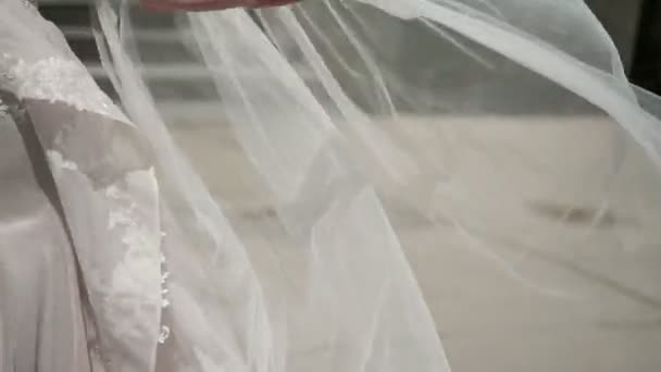 Young bride waving veil at windy day — Stock Video