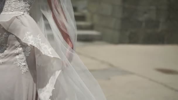 Young bride waving veil at windy day — Stock Video