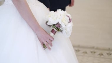 Gelin ve damat el ele tutuşuyorlar.